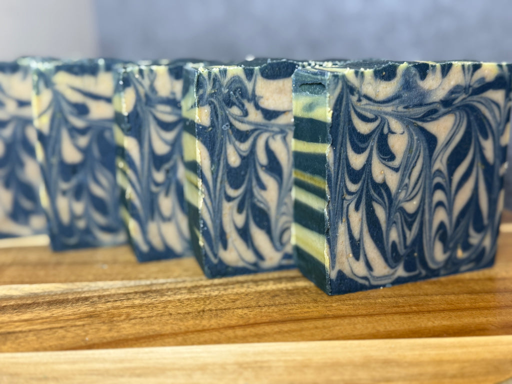 Marbled soap bars on a wooden surface with a blurred background